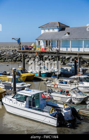 General view of the Ventnor Haven Fishery and takeaway on the Isle of Wight with fishing boats in the foreground. Stock Photo