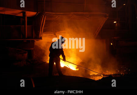 Team member taking iron samples using a lance on Blast Furnace No 5 at Port Talbot Steelworks South Wales UK Stock Photo