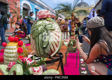 Holy Week (Semana Santa) carpet of colored sawdust (alfombras) being prepared on Antigua street. Fruit and Vegetables Carpet In Stock Photo