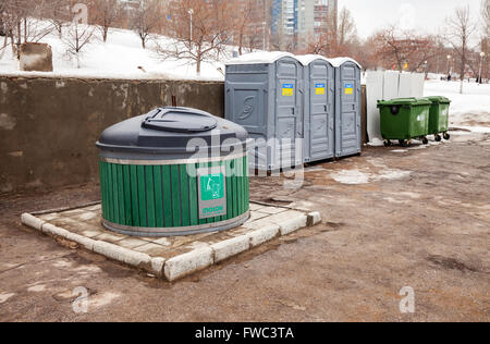 Public toilets and garbage cans on city street Stock Photo