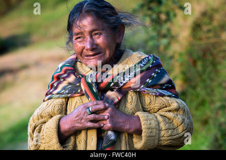 Elderly Mayan woman Guatemala walking. Maya woman wearing traditional dress in the mountains near Guatemala city. Stock Photo