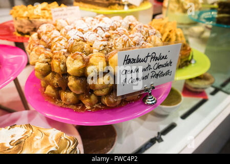 Hazelnut praline cream with caramel profiteroles dessert on display in a restaurant Stock Photo