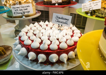 Strawberry cheesecake dessert with mini meringues on display in a restaurant Stock Photo