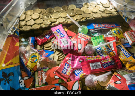 Tuppeny nudger coin-drop machine with 20c Euro coins, and lots of Maoam sweets Stock Photo