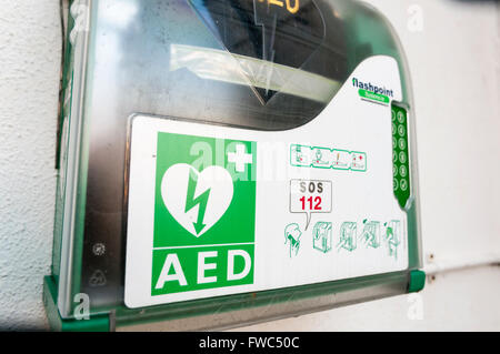 Automated External Defibrillator (AED) inside a case with a key code lock to prevent unauthorised removal. Stock Photo