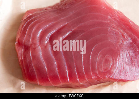 Close up of a yellow-fin tuna steak on butchers paper Stock Photo