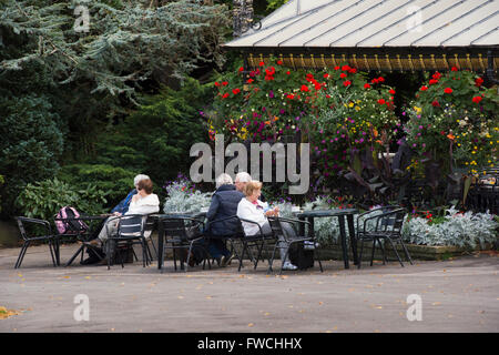 Valley Gardens, Harrogate, Yorkshire, England -  people enjoying leisure time, relaxing and drinking alfresco, at the café in this beautiful park. Stock Photo