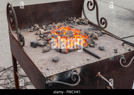 Forge fire in blacksmith's where iron tools are crafted Stock Photo