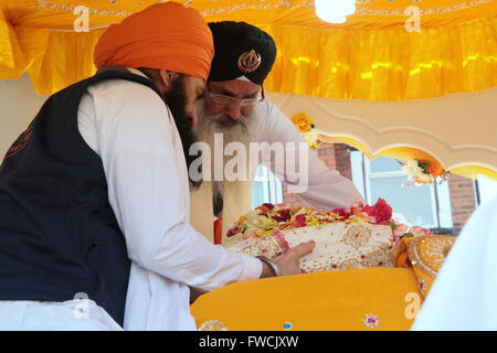 Hounslow, London, UK. 3th.April, 2016.  The Sikh Holy book is taken from the  Gurdwara Guru Nanak Nishkam Sewak Jatha temple marking the beginning of  Vaisakhi Nagar Kirtan.Vaisakhi is a harvest festival commemorating the initiation of the first five members of the brotherhood of the Khalsa, which took place on April 13 1699 - a key date in the development of the Sikh faith.@Paul Quezada-Neiman/Alamy Live News Stock Photo