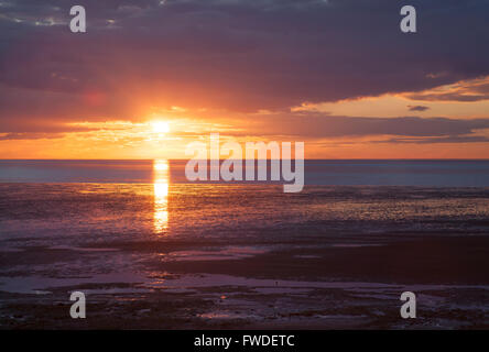 Setting sun at Heacham in The Wash, springtime. Stock Photo