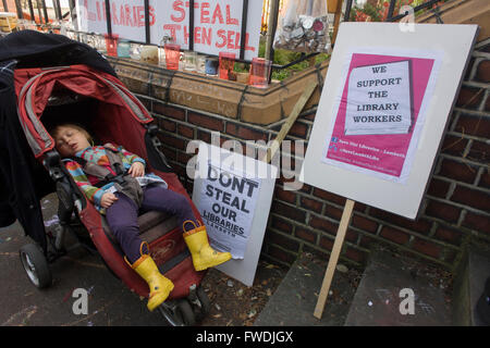 London, UK 2nd April: A young protester sleeps outside the now closed Carnegie Library, in Herne Hill, south London on 2nd April 2016. The angry local community in the south London borough have occupied their important resource for learning and social hub for the weekend. After a long campaign by locals, Lambeth have gone ahead and closed the library's doors for the last time because they say, cuts to their budget mean millions must be saved. A gym will replace the working library and while some of the 20,000 books on shelves will remain, no librarians will be present to administer it. London Stock Photo