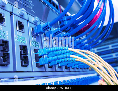 Fiber Optic cables connected to an optic ports Stock Photo