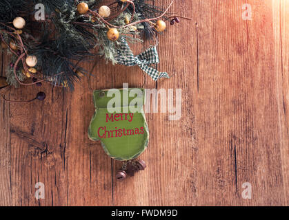 christmas wooden decorations - palm and christmas tree hanging on rope in front of wooden background Stock Photo