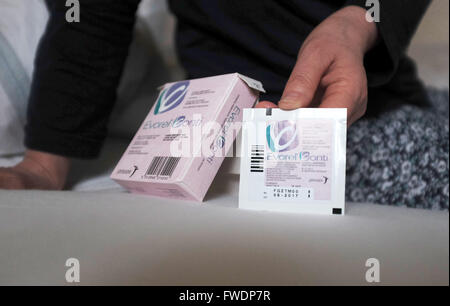 Middle aged woman using Evorel Conti HRT patches to help with the menopause Hormone Replacement Therapy treatment Stock Photo