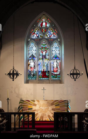 Altar and Stained Glass window in St Nicholas Church, Hatherop, Cotswolds,  Gloucestershire, England Stock Photo