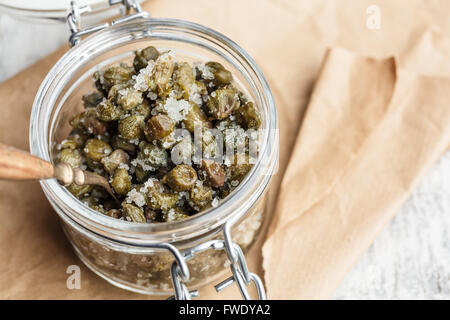 Salted capers in glass jar Stock Photo