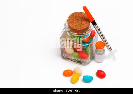 A syringe and candy bottle isolate on white background. Protect Against Diabetes. Stock Photo