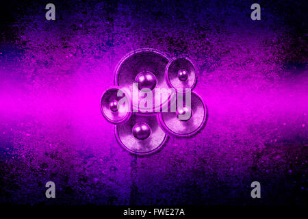Audio speakers on a purple and black concrete wall background Stock Photo