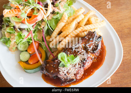 Delicious barbecued ribs with spicy sauce and organic salad, stock photo Stock Photo