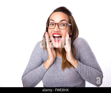 young woman looking excited against white background Stock Photo