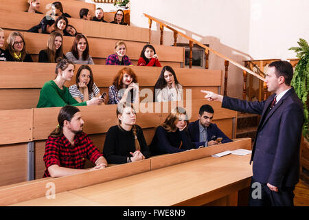 Teacher explaining something to students Stock Photo