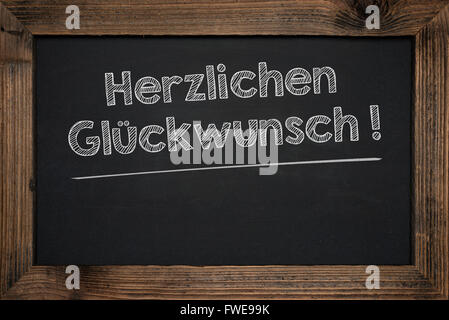 Chalkboard handwriting business success in German. Stock Photo