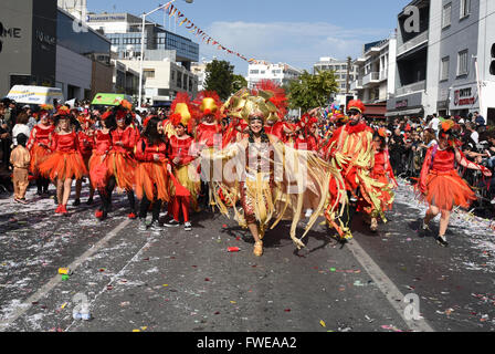 Happy people in teams dressed with colorful costumes at famous Limassol Carnival Parade. Stock Photo