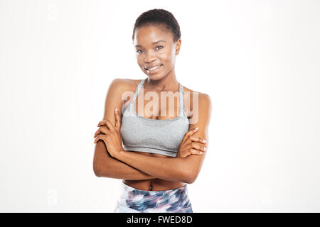 Portrait of happy beautiful young african american sportswoman standing with arms crossed over white background Stock Photo