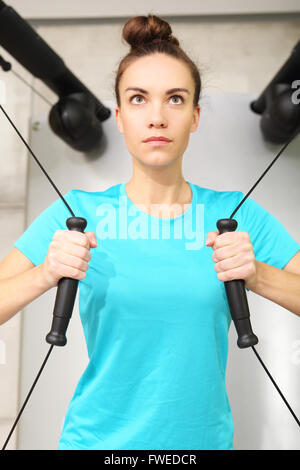 Workout at the gym. Rehabilitation, training with rubbers. Gym, exercise the muscles of the back. Gym, training with rubbers. Stock Photo
