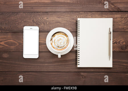 phone coffee and book blank on wood table top view Stock Photo