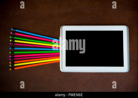 Wooden desktop with colorful pencil and tablet black screen Stock Photo