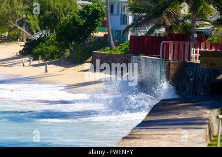 Giant waves pound this storm sea wall on the north shore of Oahu Hawaii during a storm in tropical paradise. Stock Photo