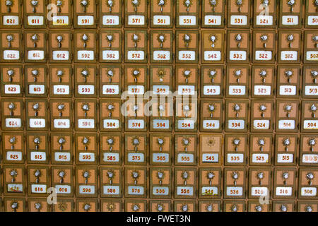 This photo shows the many po boxes at the post office. The mail boxes are lined up in rows and columns for organization. Stock Photo