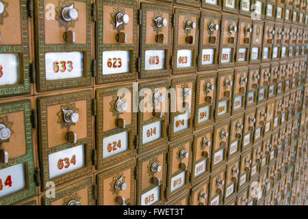 This photo shows the many po boxes at the post office. The mail boxes are lined up in rows and columns for organization. Stock Photo