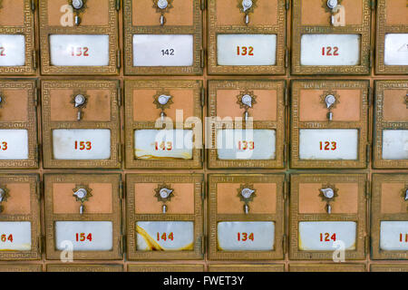 This photo shows the many po boxes at the post office. The mail boxes are lined up in rows and columns for organization. Stock Photo