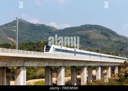 Hainan, China - The view of a Highspeed Trains driving pass by a viaduct in the daytime. Stock Photo
