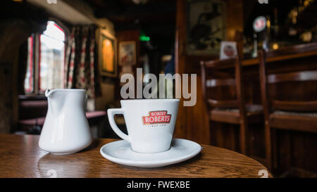 Robert Roberts coffee on the table of an Irish Pub. Stock Photo