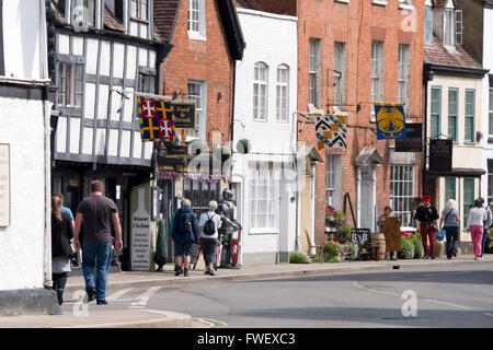 Tewkesbury, UK - July 17, 2015: Shops decorated with Medieval Heraldric flags on 17 July 2015 at Church Street, Tewkesbury Stock Photo