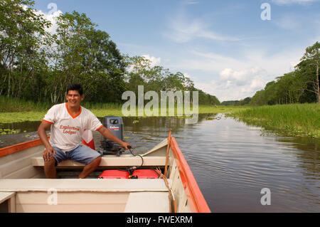 Amazon rainforest: Expedition by boat along the Amazon River near Iquitos, Loreto, Peru. Navigating one of the tributaries of th Stock Photo