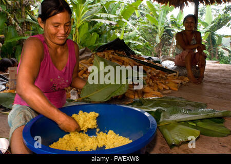 Woman preparing Juanes tamales of rice and chicken by traditional method in Timicuro I, Iqutios peruvian amazon, Loreto, Peru. Stock Photo