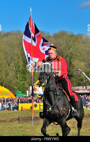 Household Cavalry soldier charging across the showgrounds  with the union flag during The Musical Ride of the Household Cavalry Stock Photo