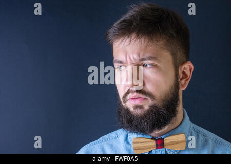 Angry bearded man in a blue shirt Stock Photo