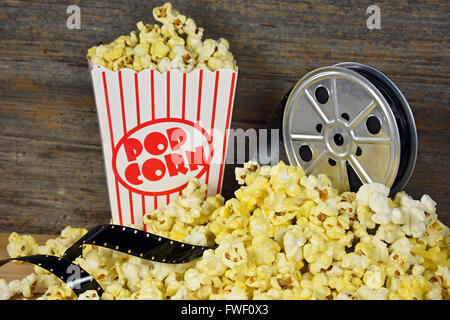 Old movie reel and film with popcorn. Stock Photo