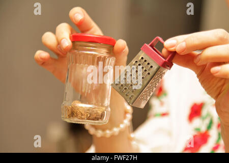 Gater for cheese in the hands of women Stock Photo