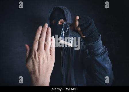 Saying No to drug dealer offering narcotic substance, fight addiction, unrecognizable hooded criminal offering drugs Stock Photo