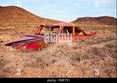 Junk car artistically buried in the desert near Goldfield, Nevada Stock Photo