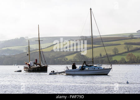 sailing on the river dart, boats at stoke gabriel with dittisham in the background, River Dart estuary and the tranquil mill pon Stock Photo