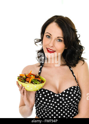Healthy Young Woman Holding A Bowl of Fresh Crisp Garden Salad Isolated Against A White Background Stock Photo