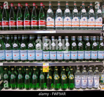 Rows of name brand sparkling bottled waters on grocery store shelves. Stock Photo