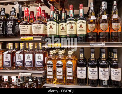 bottles of alcohol on the shelves of a liquor store Stock Photo